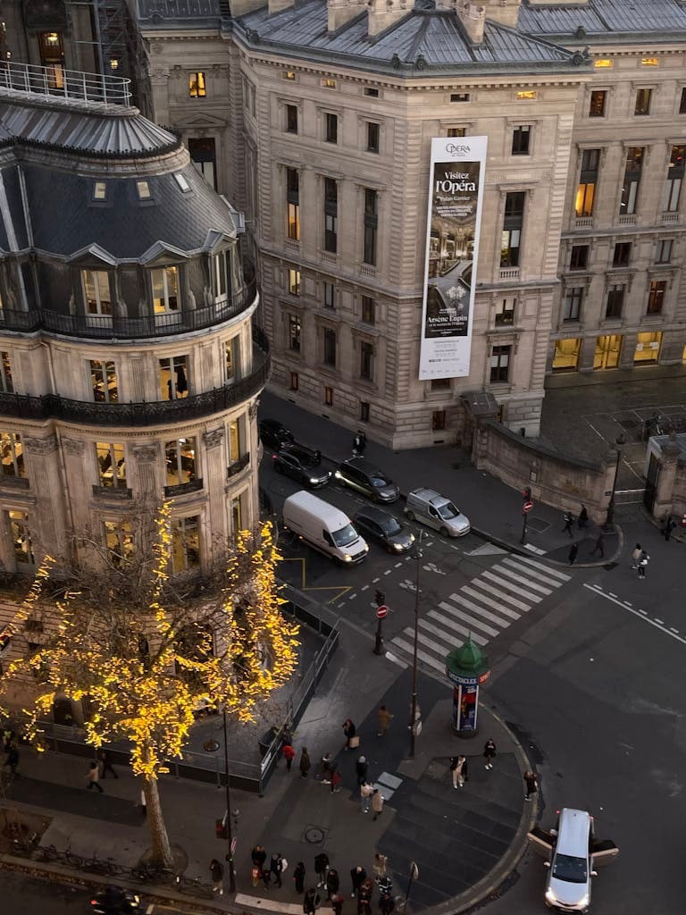 Elegant Paris street view from above featuring iconic architecture and city life.