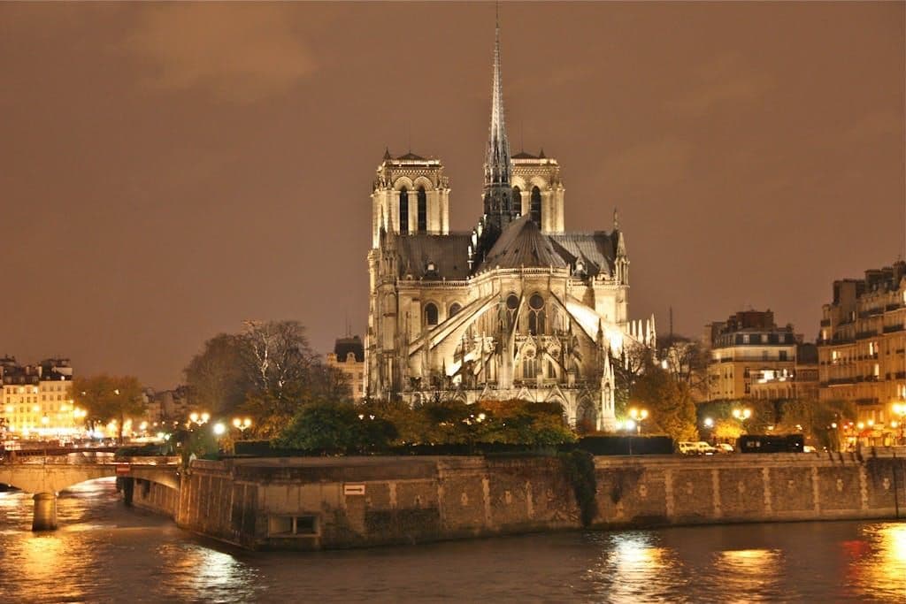 A stunning night view of the illuminated Notre Dame Cathedral in Paris, France. Ile de la cite